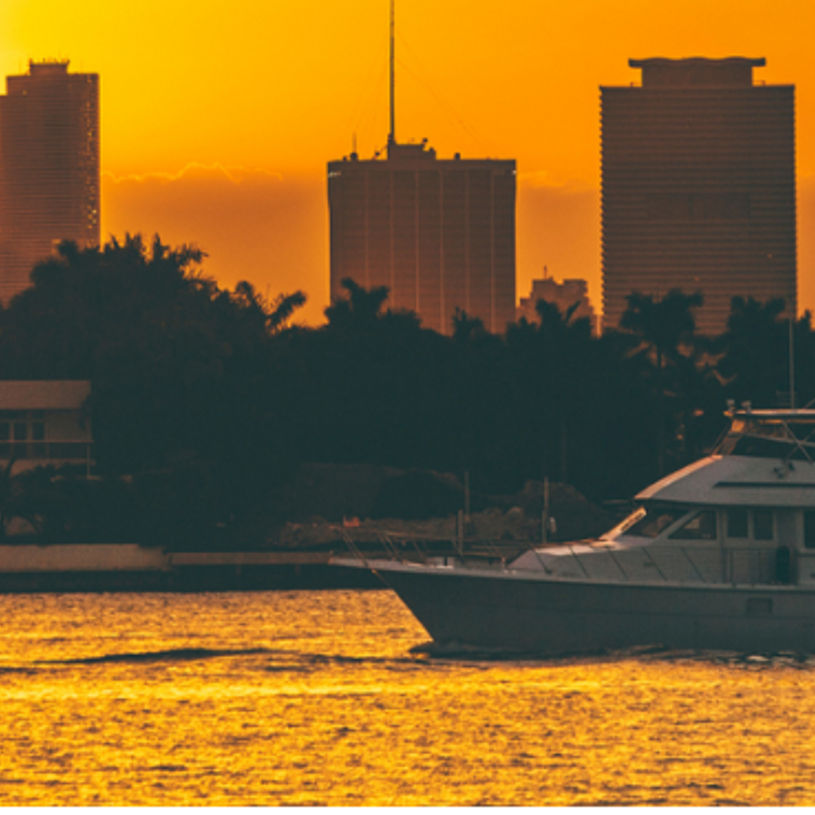 Sunset view over Biscayne Bay with yachts cruising on the water
