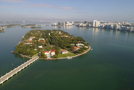 Aerial view of the exclusive Star Island with luxury estates surrounded by the clear waters of Miami