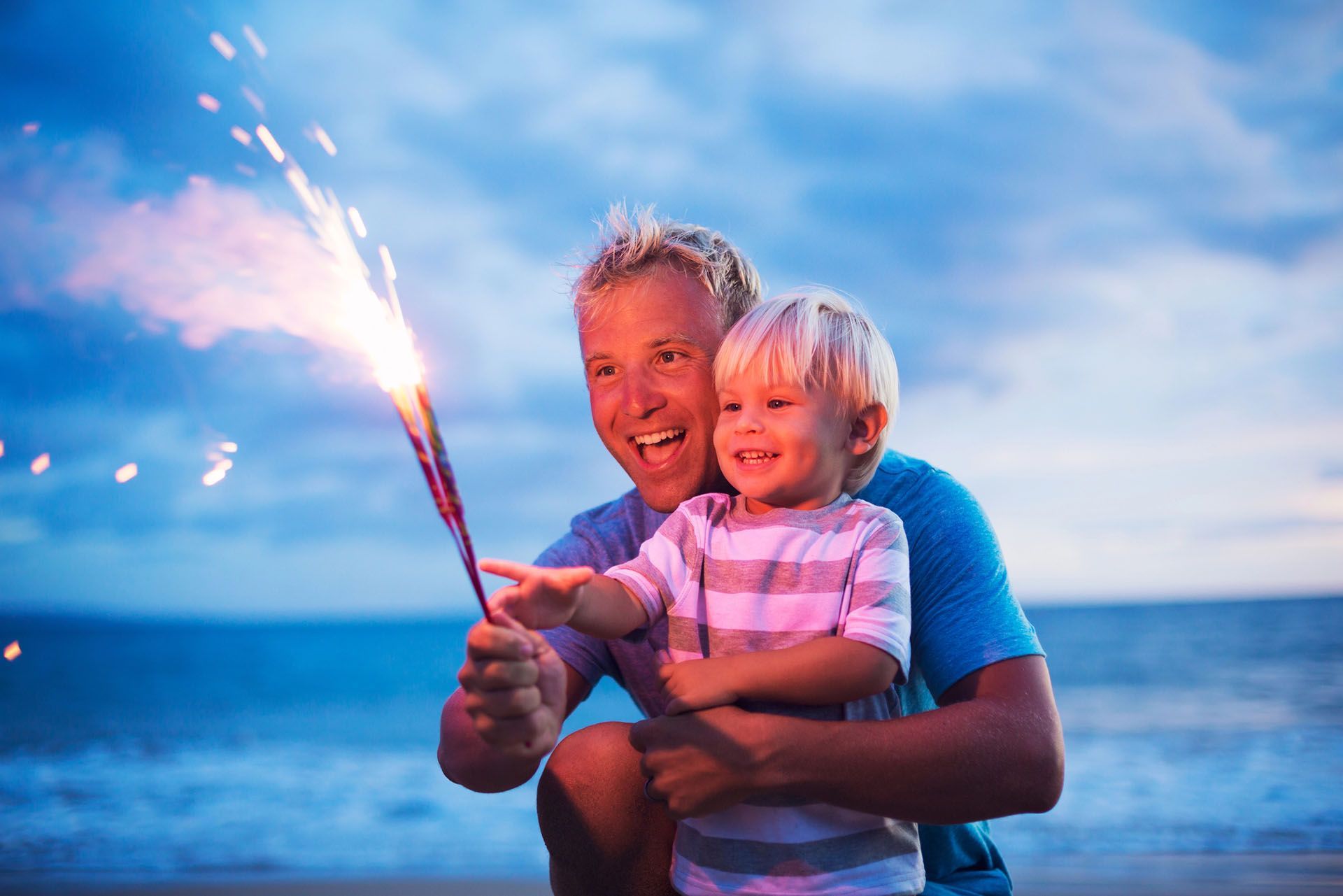 4th Of July Fireworks Celebration - Father And Son Lighting Fireworks