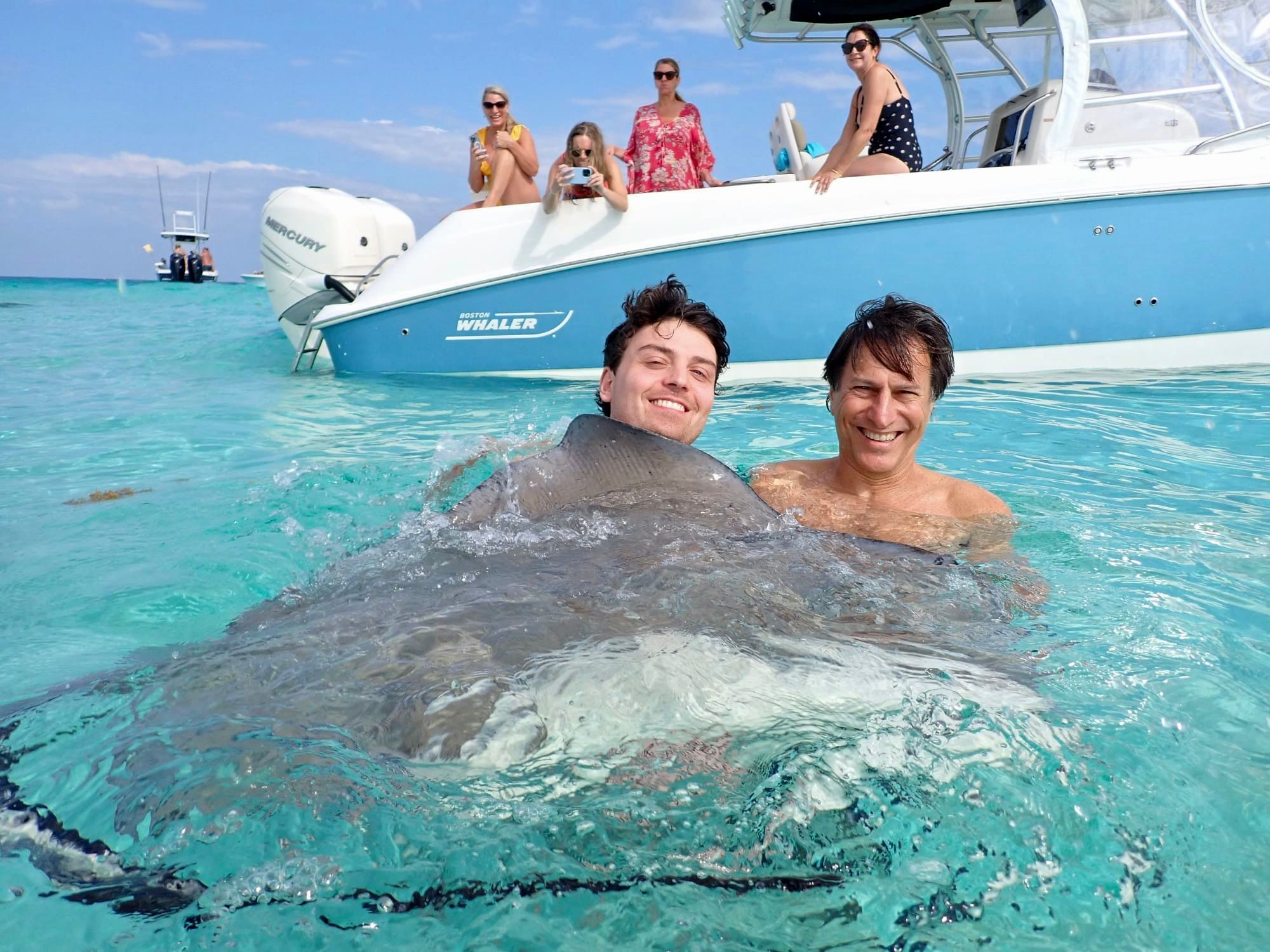 Human Interaction With Stingrays At Stingray City Sandbar