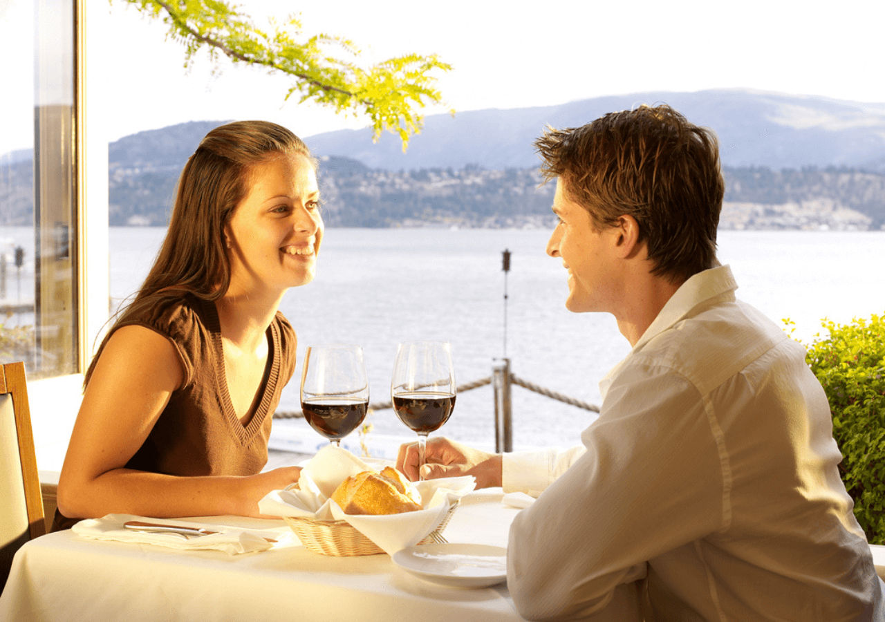 Couple dining lakeside at Hotel Eldorado in Kelowna