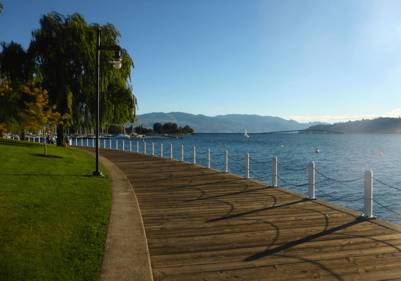 Downtown Kelowna Boardwalk along the lake with trees in the background