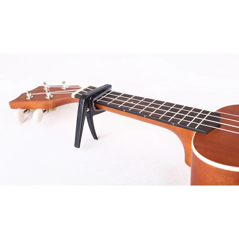 Description Picture 3 of itemProfessional Ukulele Capo 4 Strings Hawaii Guitar Capos Single-Handed Quick Replacement Change Guitar Parts & Accessories