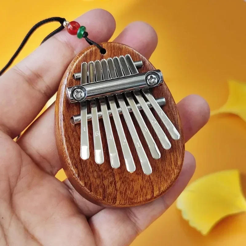 Description Picture 4 of itemNewest 8 Key Mini Kalimba Thumb Piano Wooden/Acrylic Small Wearable Musical Instrument Pendant Mbira Finger Piano For Adult Kids