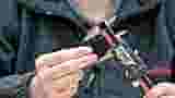 Close up of hands demonstrating how to measure the panel hole size of a Blind Grommet.