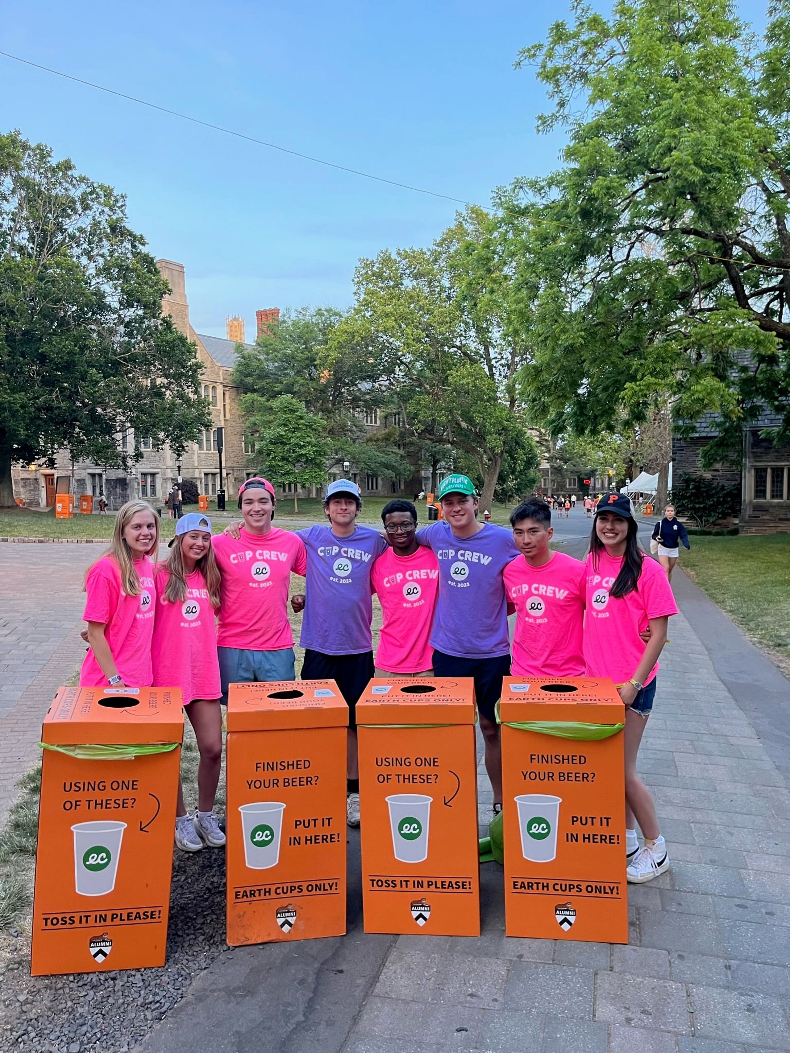 Princeton Reunions Cup Crew standing behind orange collection bins labelled Earth Cups only