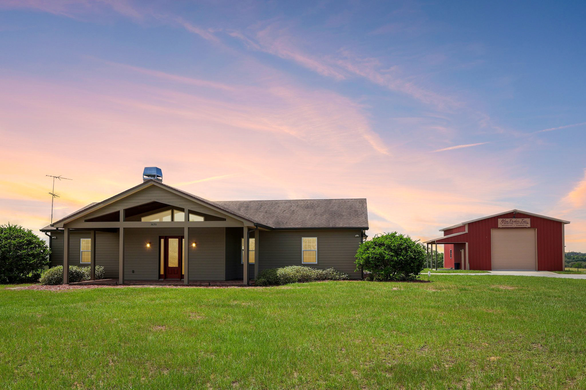 Central Florida acreage property and detached building shown with twilight atmosphere