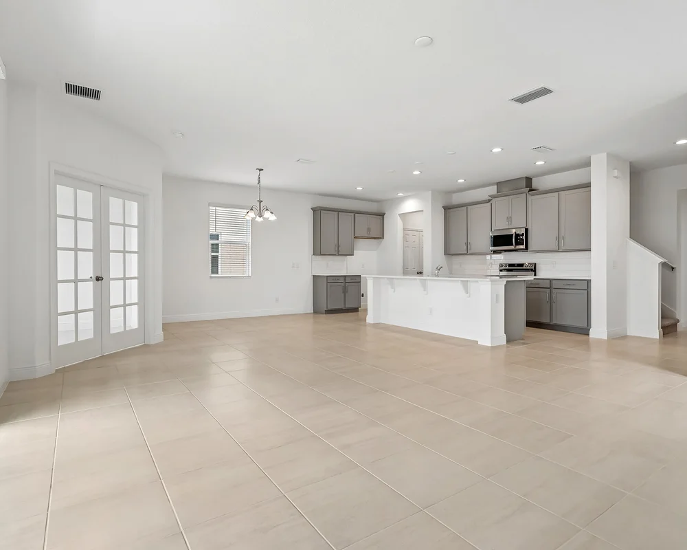 Wide-angle empty new construction interior showing room scale and floor plan flow