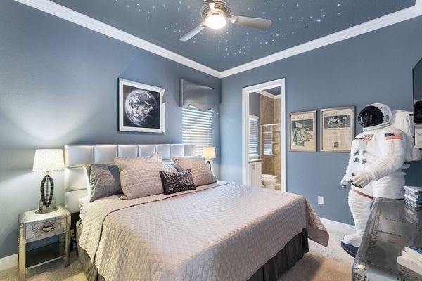 This out of this world bedroom is perfectly decorated with star lights built into the ceiling and a life size Astronaut