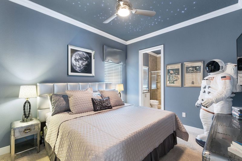 This out of this world bedroom is perfectly decorated with star lights built into the ceiling and a life size Astronaut