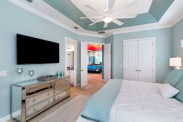 This bedroom has a 65 inch SMART TV