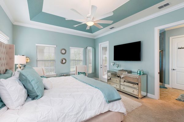 The master bedroom features a King size bed, en-suite bathroom, and private balcony with view to the pool area
