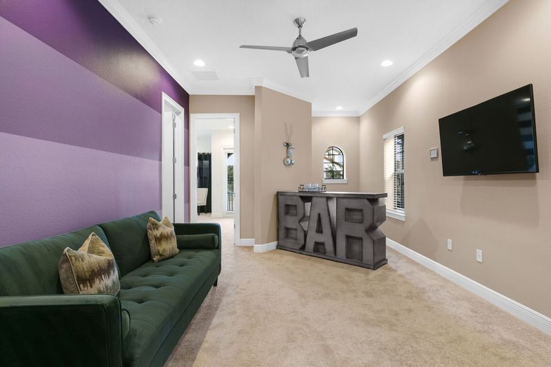 The second floor loft spaces offers an additional TV area with a wetbar
