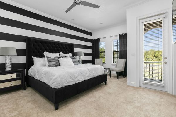 This second floor bedroom has another king bed and balcony access