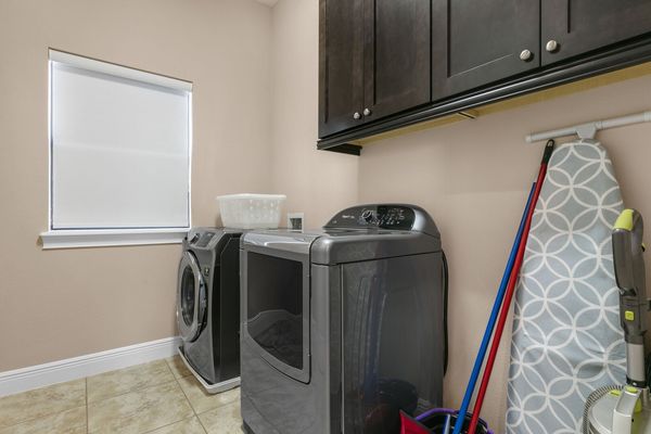 The laundry room has a washer and dryer