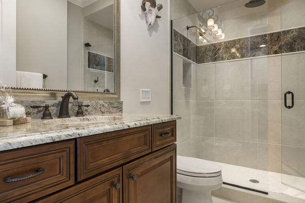 Enjoy a rainfall shower head in this en-suite bathroom