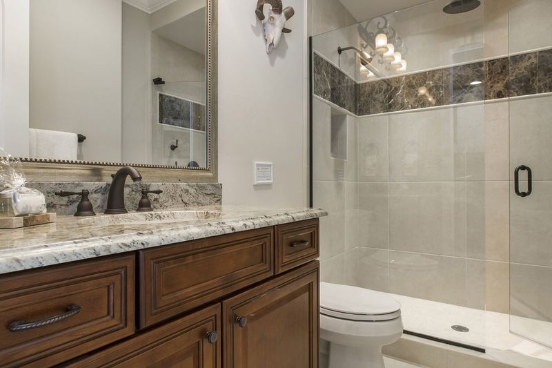 Enjoy a rainfall shower head in this en-suite bathroom