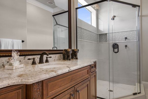 The en-suite bathroom offers a rainfall shower head