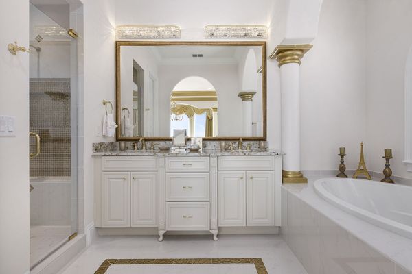 The en-suite bathroom is elegantly appointed and features both a soaking tub and glass shower
