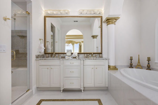 The en-suite bathroom is elegantly appointed and features both a soaking tub and glass shower