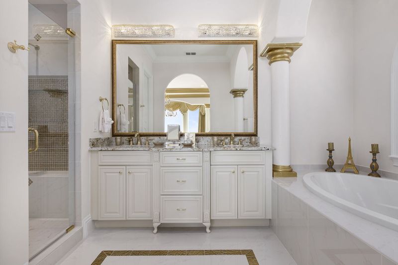 The en-suite bathroom is elegantly appointed and features both a soaking tub and glass shower