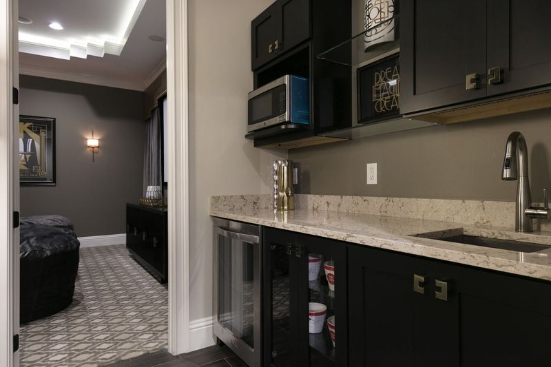 The theater room has a wet bar, wine cooler/fridge, and microwave