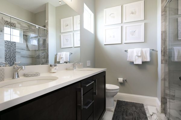 The en-suite bathroom has a glass door walk-in shower and dual vanity