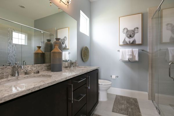 Master en-suite bathroom features glass door walk-in shower and dual vanity