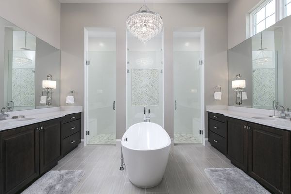 En-suite bathroom features glass door walk-in shower with large tub, and dual vanity