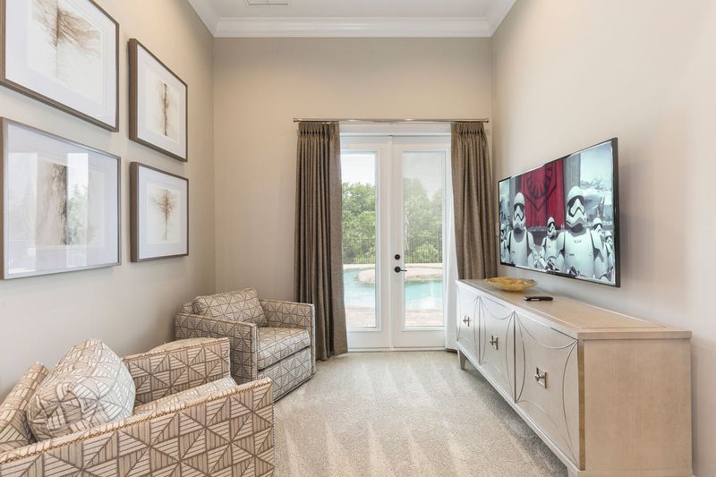 There is a seating area with 50-inch SMART TV and access to the pool area
