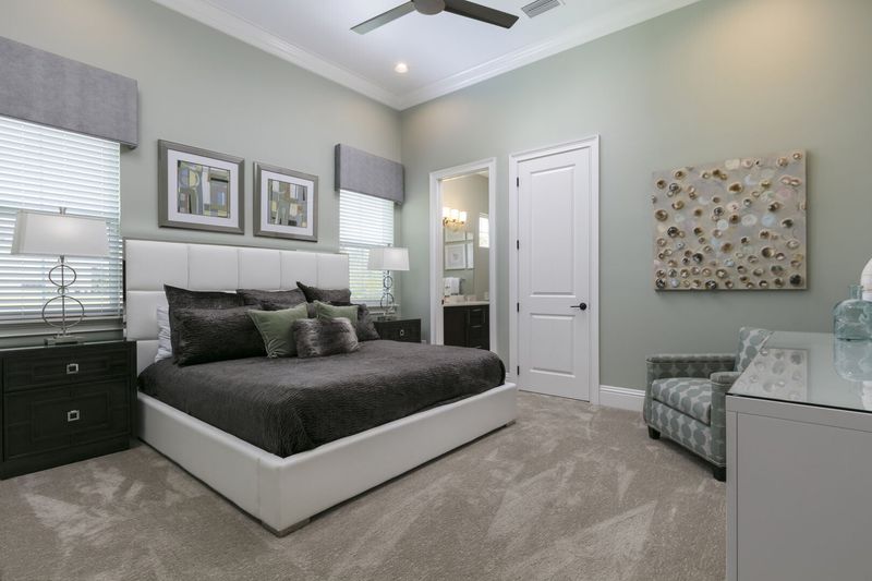 This master suite located on the ground floor features a king size bed, en-suite bath, and 50-inch SMART TV