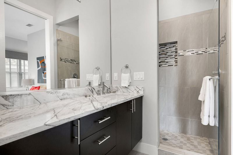 En-suite bathroom 2 has marble vanity and glass door walk-in shower