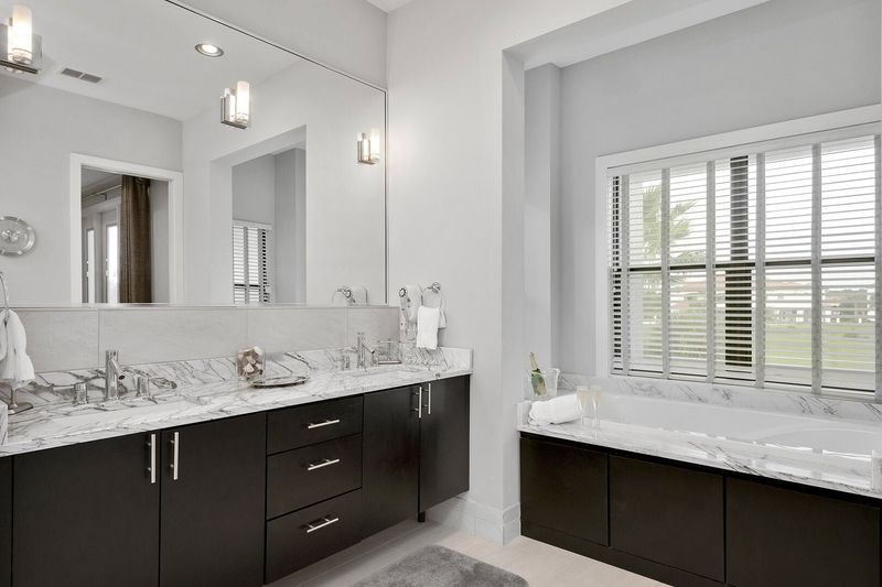 The master en-suite bathroom features marble dual vanity and garden tub for relaxation