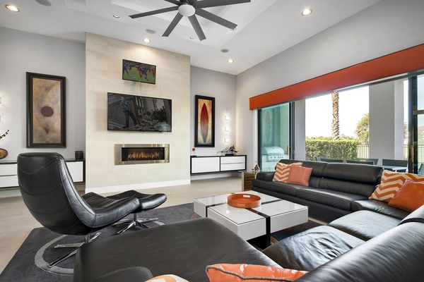 The living area features a 65-inch TV and 32-inch TV