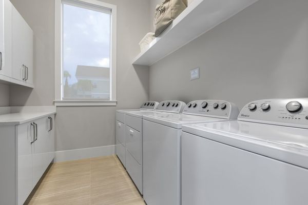 The ground floor laundry room has 2 sets of washers and dryers