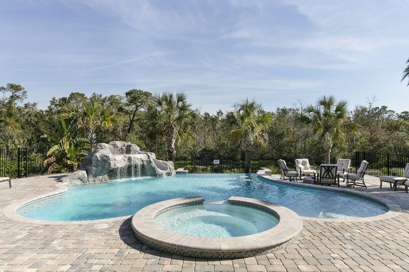 The pool also features a grotto sitting are