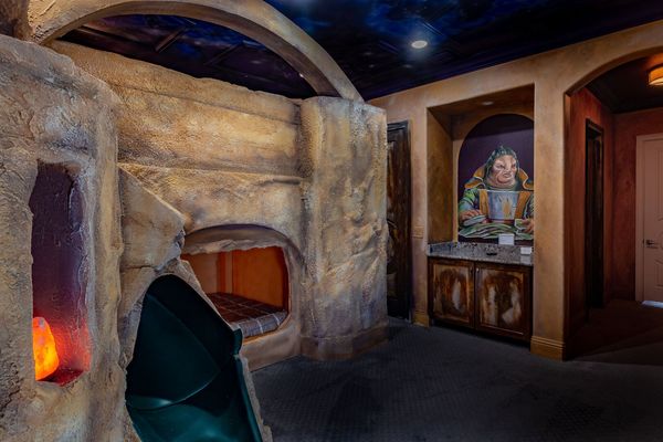 This custom built bunk has two full-size beds and a slide