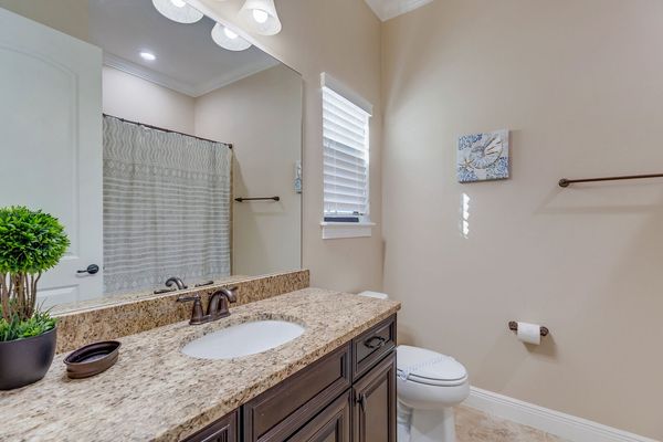 The en-suite bathroom includes a combo tub/shower