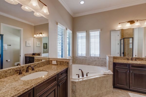 The master bathroom has double sinks and a relaxing bath tub