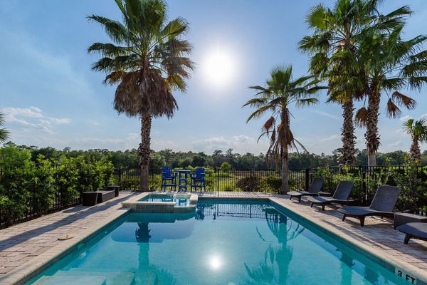 The pool area features a view of the Jack Nicklaus golf course