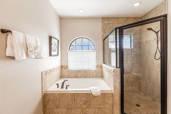A glass walk-in shower and garden tub