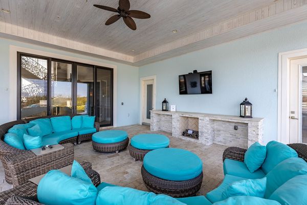 The covered lanai features a TV, and plenty of seating for all (Disclaimer: Fireplace(s) not allowed for guest use, homeowner use only.)