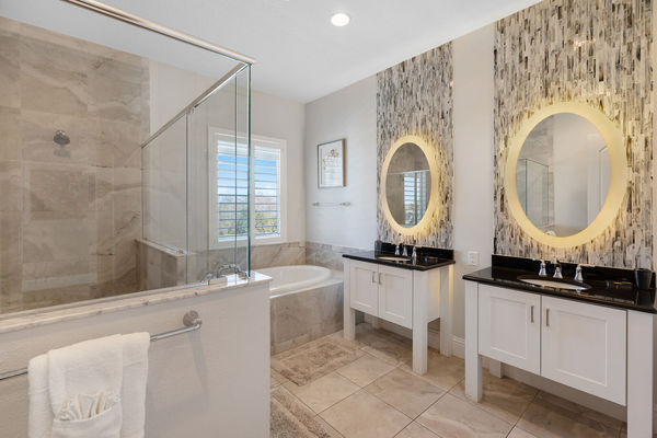 Master en-suite bathroom with glass walk-in shower and garden tub