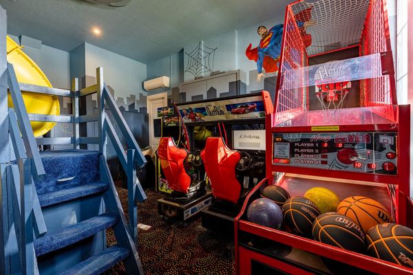 The games room features an air hockey table, 70-Inch TV, and awesome slide