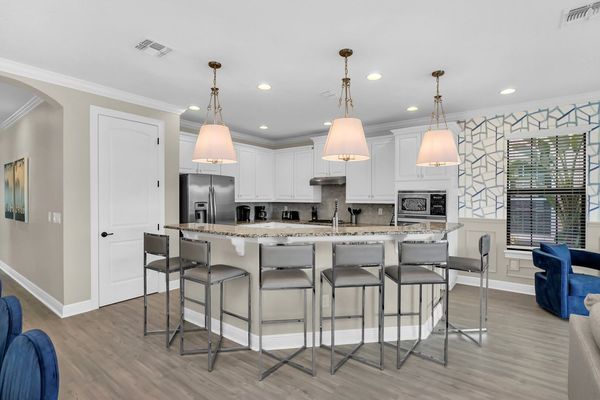 Fully equipped kitchen with stainless steel appliances and breakfast bar with seating for 6