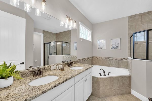 En-suite master bathroom has a walk in shower, garden tub, and dual vanity