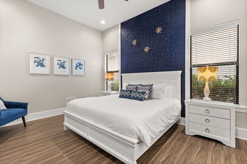 Calming navy and grey master bedroom with a king bed located on the ground floor