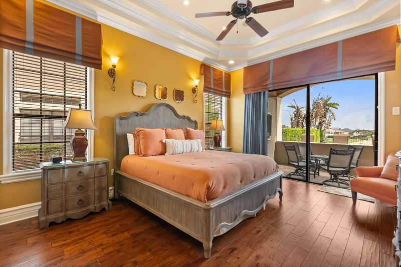 Decorative downstairs master suite bedroom 2 featuring a beautiful tray ceiling