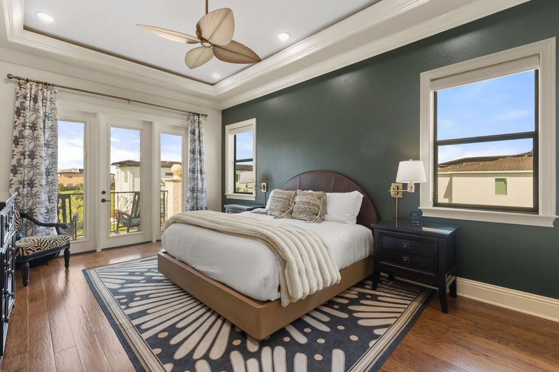 Master bedroom on the second floor with a private balcony