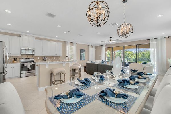 A gorgeous formal dining table has 6 seats and a bench for 4 for a total of 10 guests